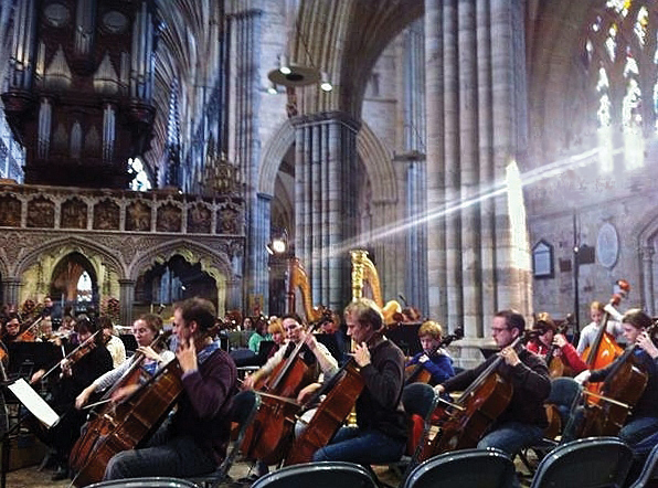 Photo of musicians playing in a cathedral